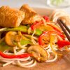 catfish stir fry with noodles, veggies and chopsticks