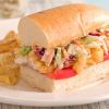 catfish poboy on white bread bun with potato chips