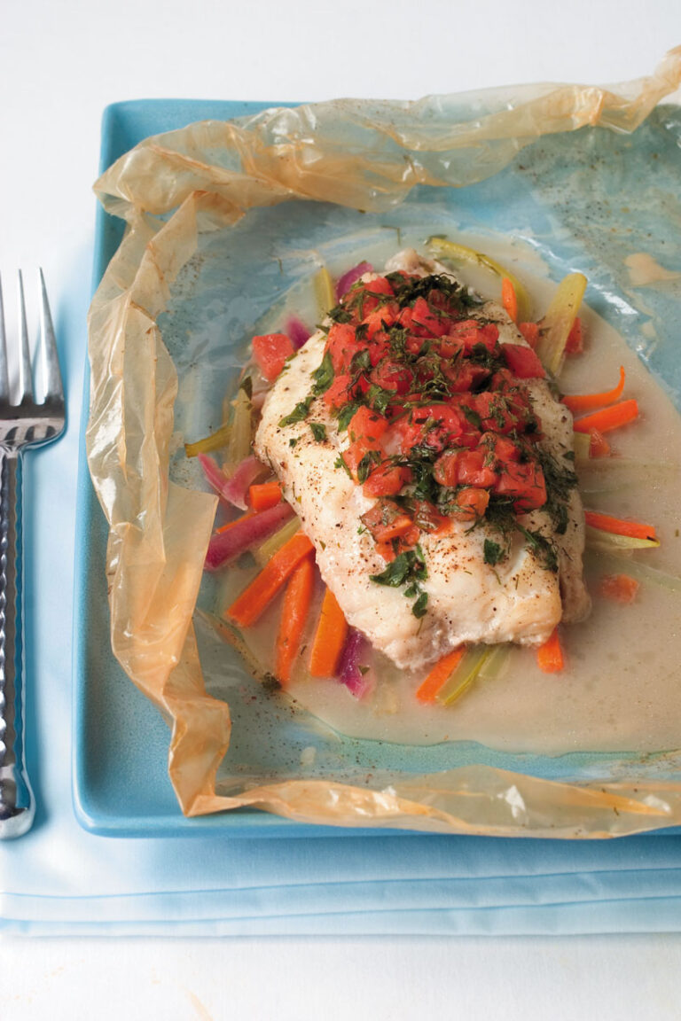catfish papillote on bed of vegetables and topped with tomatoes