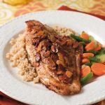 catfish almondine on bed of couscous with side of vegetables