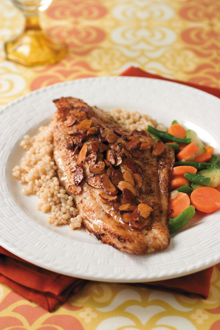 catfish almondine on bed of couscous with side of vegetables