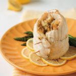 crab stuffed catfish rollups on orange plate