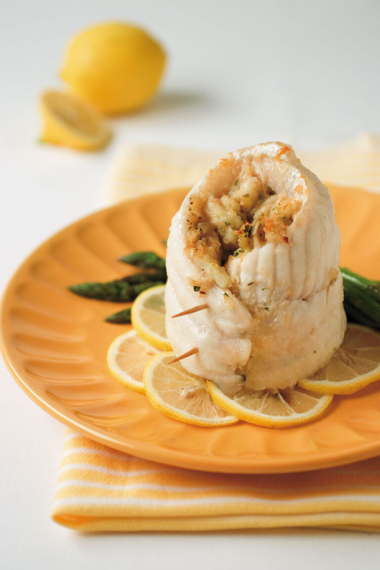 crab stuffed catfish rollups on orange plate