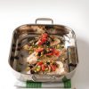 mediterranean catfish topped with olives and tomatoes in baking pan