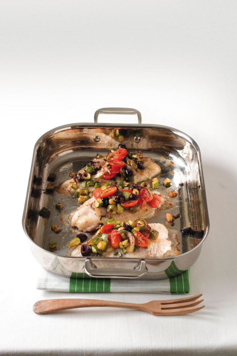 mediterranean catfish topped with olives and tomatoes in baking pan