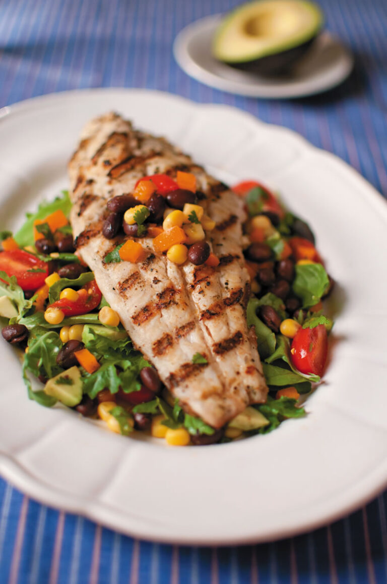jerk catfish on bed of salad with fresh veggies