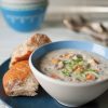 catfish chowder in bowl with side of bread