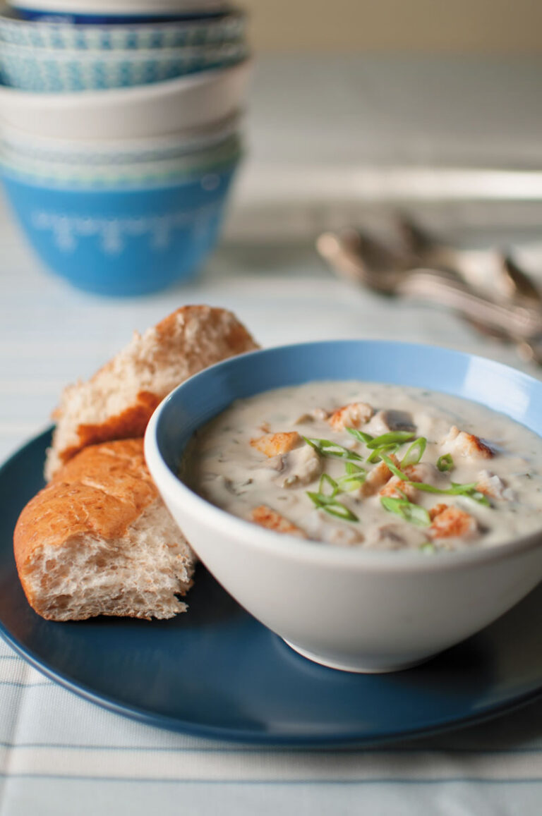 catfish chowder in bowl with side of bread