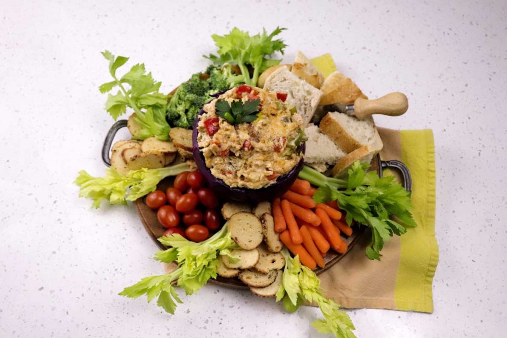 Catfish gumbo dip surrounded by vegetables and bread