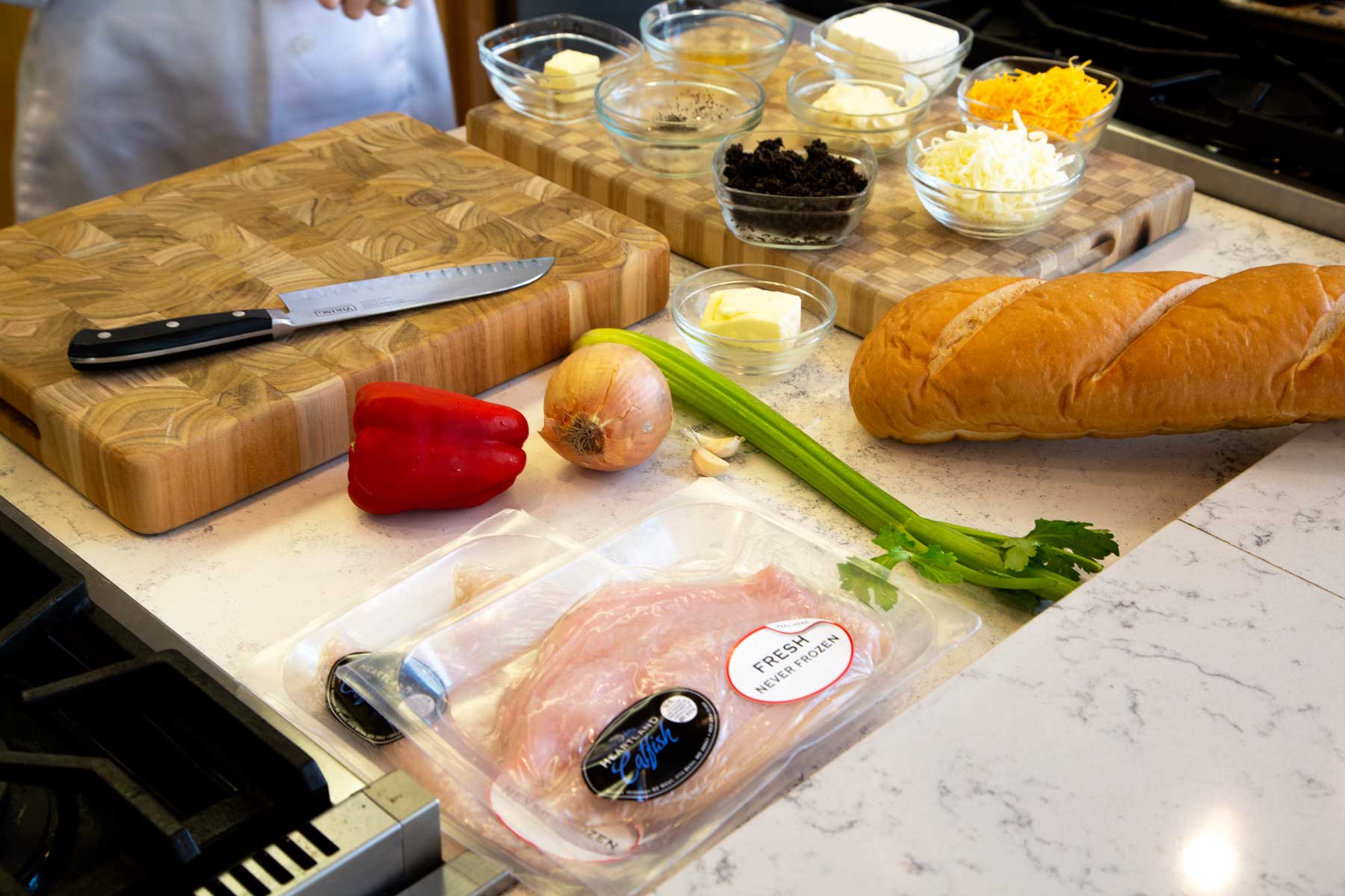 Cooking ingredients including catfish fillets, vegetables and bread