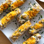 Plated catfish cheesy bread topped with parsley