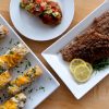 Plates of catfish cheesy bread, catfish cakes and pecan crusted catfish