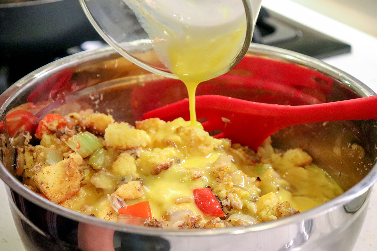 Mixing egg into Catfish cornbread dressing