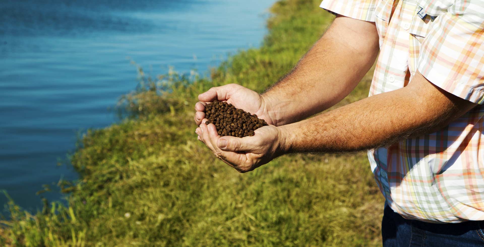 Farmer holding Catfish Protein Feed