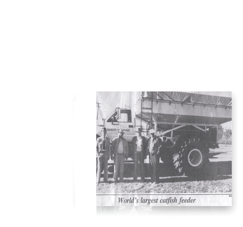 Black and white newspaper clipping of Tackett family in front of feed truck