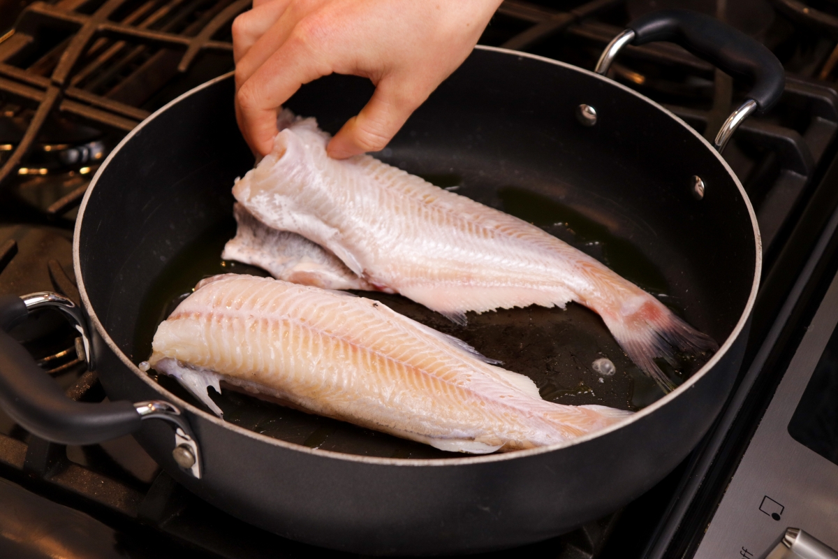 Sauteeing whole catfish in cast iron skillet