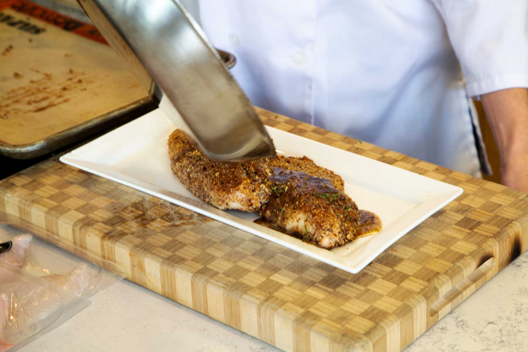 Pouring Sauce over Pecan Crusted Catfish