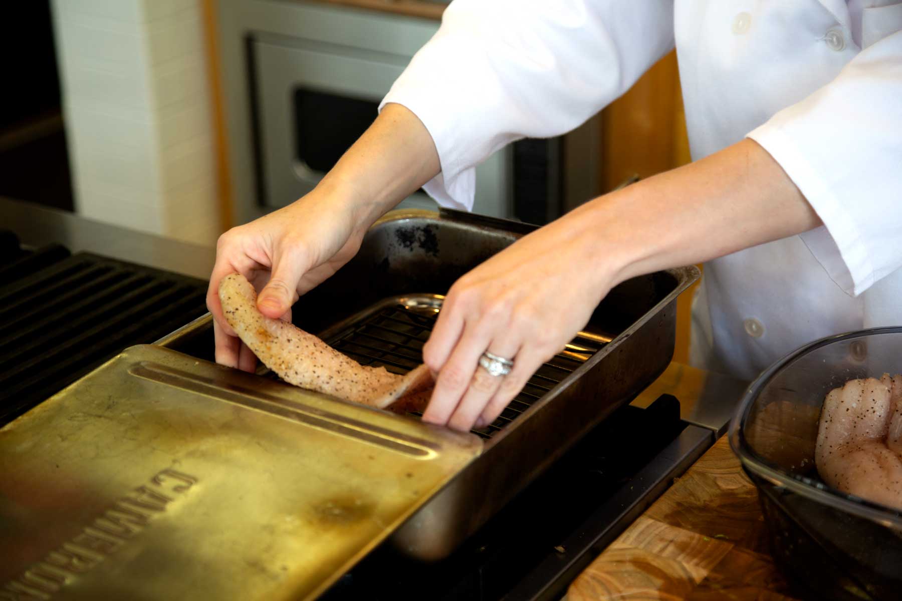 Placing Catfish fillets in Pan