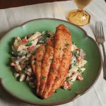 Alfredo pasta topped with cajun season catfish