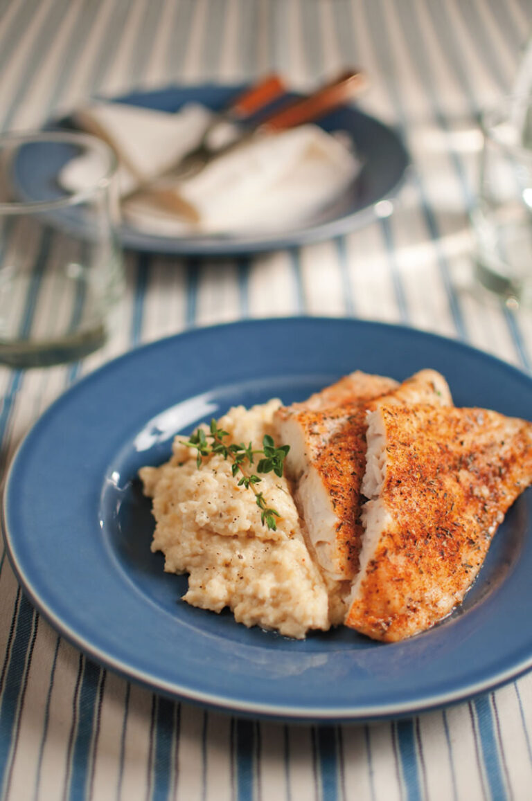 Blackened Catfish with mashed potatoes on a blue plate