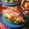 chipotle catfish sandwich with lettuce and onions