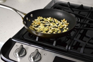 cooking onion in skillet on stove