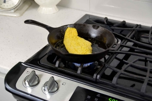 breaded catfish in a pan on stove