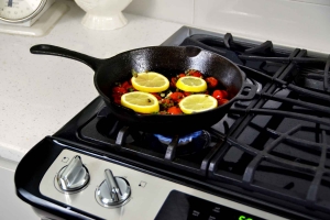 Cooking tomatoes and lemons on stovetop