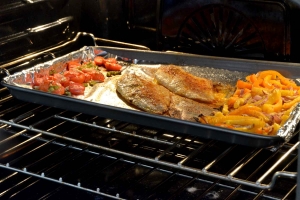 catfish fillets and veggies roasting in oven