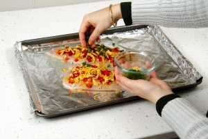 catfish on baking sheet topped with ingredients