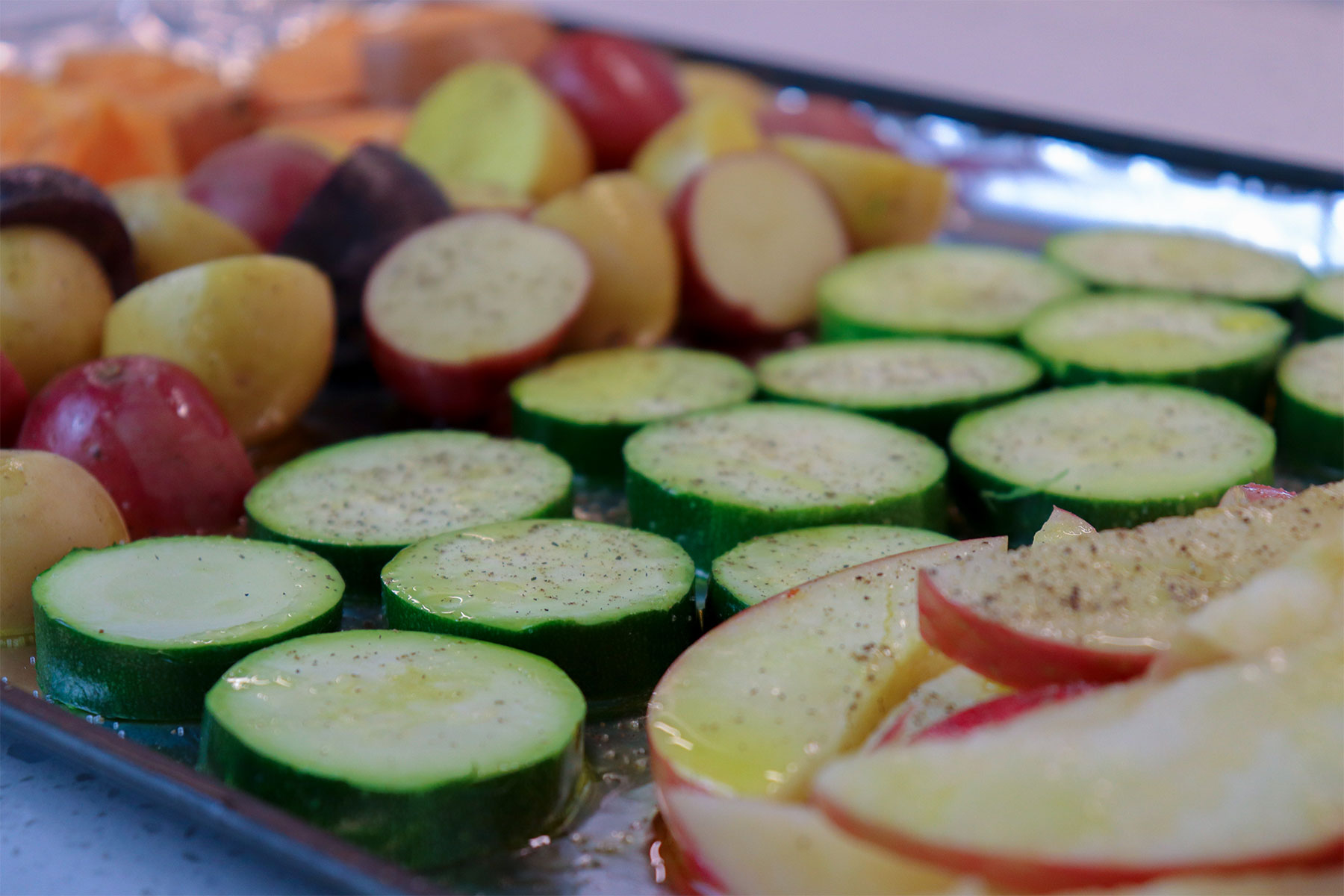 chopped Veggies on foil lined baking sheet