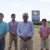 Four generations of Tackett family standing in front of Heartland Catfish sign