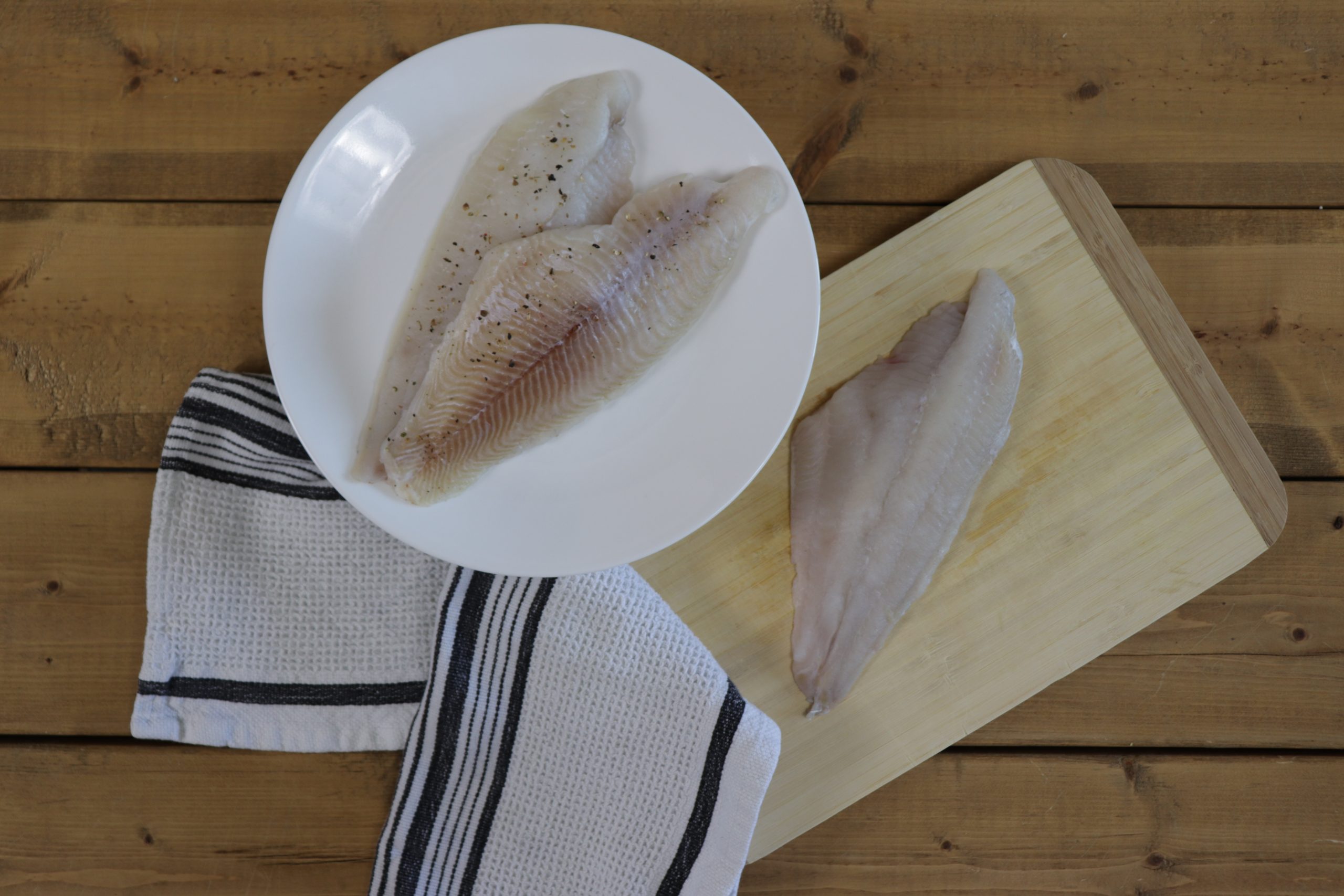 Raw Catfish on plate and cedar plank