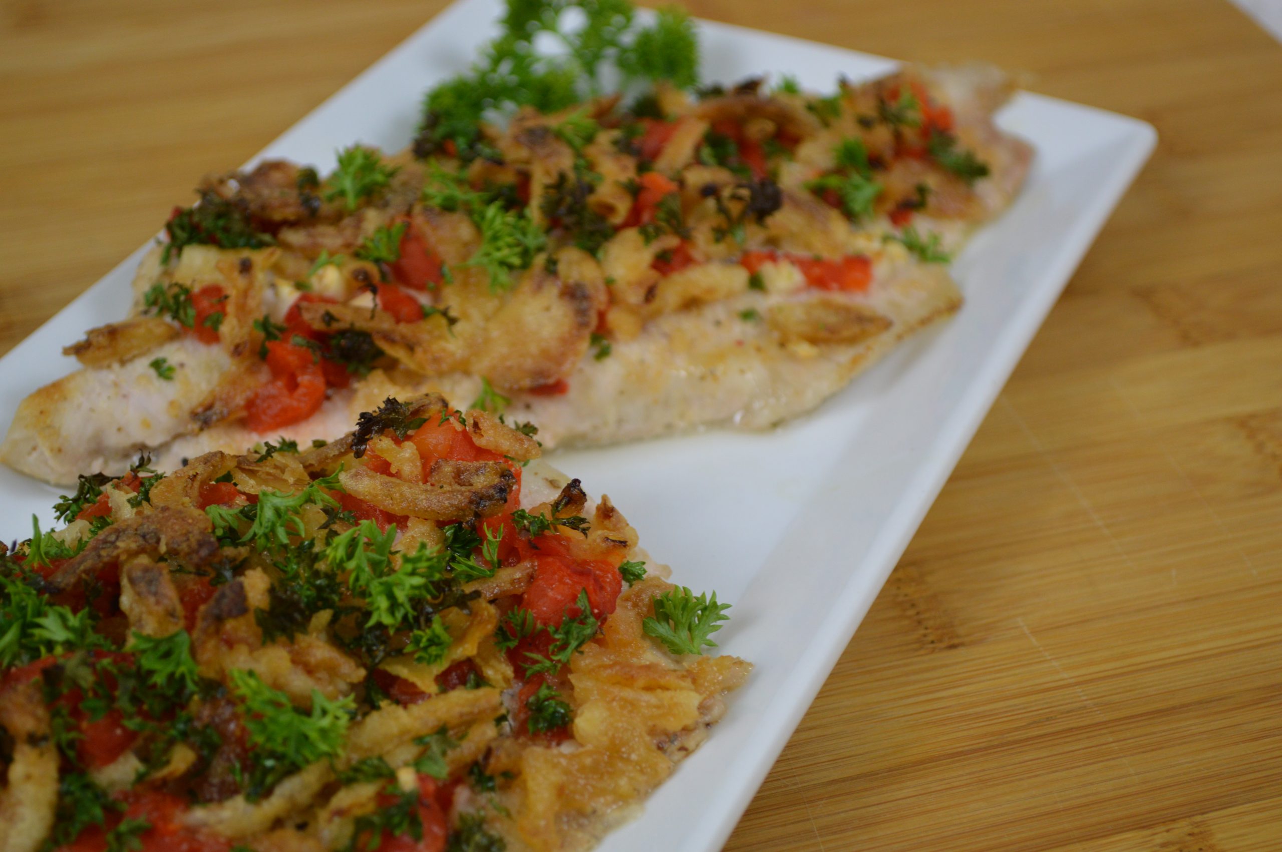 cooked catfish topped with veggies