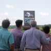 Four generations of Tackett family facing Heartland Catfish sign