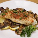 plated lemon pepper catfish on bed of mushrooms