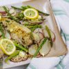 Baked catfish, potatoes and asparagus on a platter