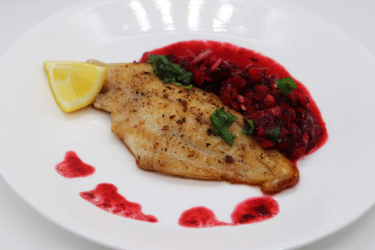 Grilled catfish fillet topped with tomato blackberry salsa