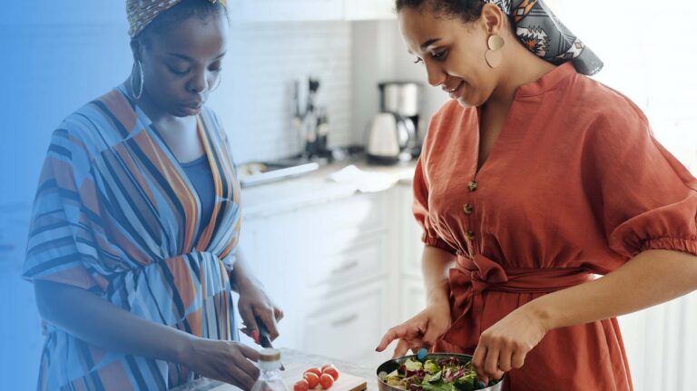 Two women preparing a salad.