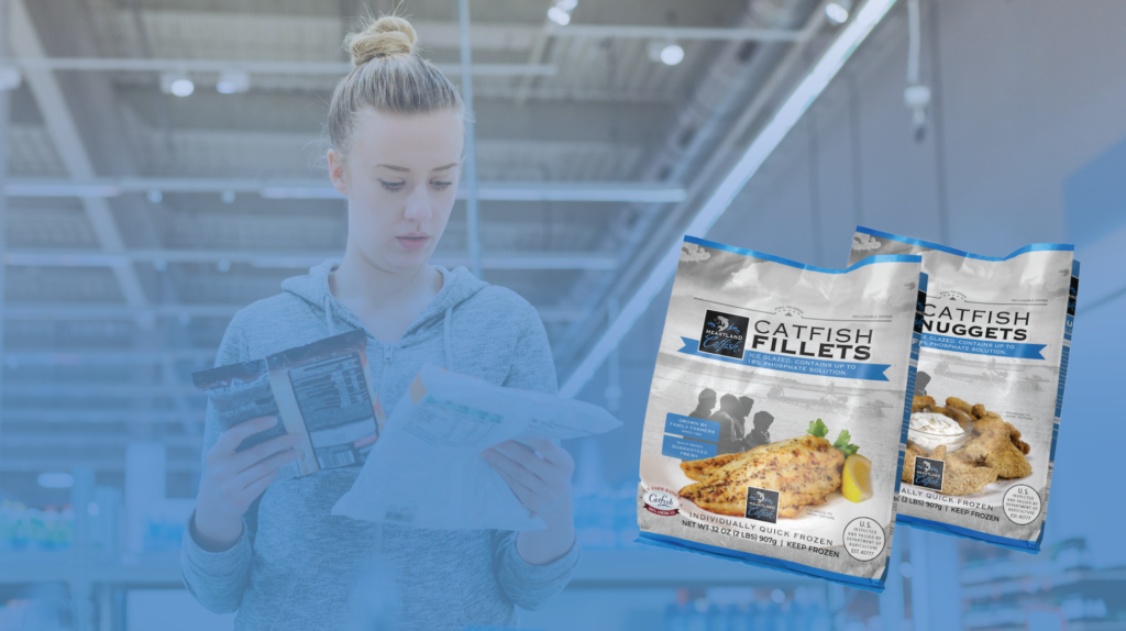 Woman looking at bags of Heartland Catfish fillets and nuggets.