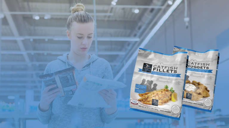 Woman looking at bags of Heartland Catfish fillets and nuggets.