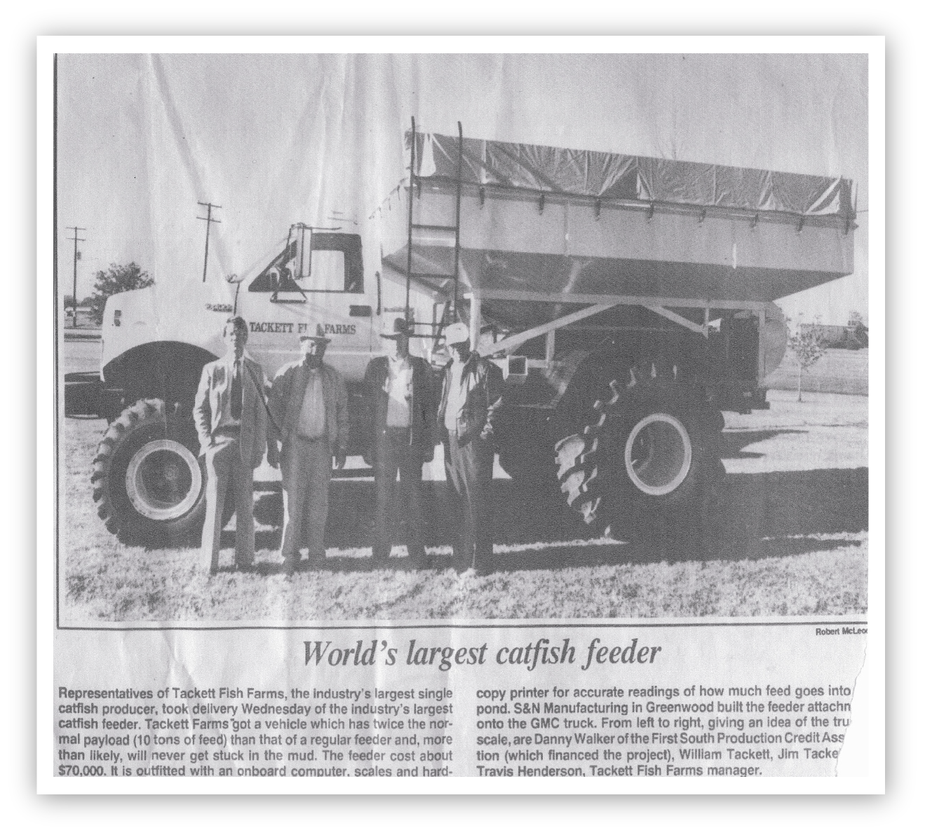 Newspaper clipping of four men in front of a Tackett Farms truck.